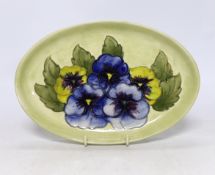 A Moorcroft oval ‘Pansy’ dish, stamp and label to the base, 23cm wide