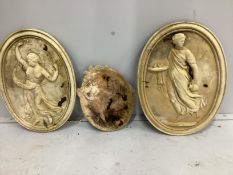 Three oval cast stone garden wall appliques, largest height 52cm