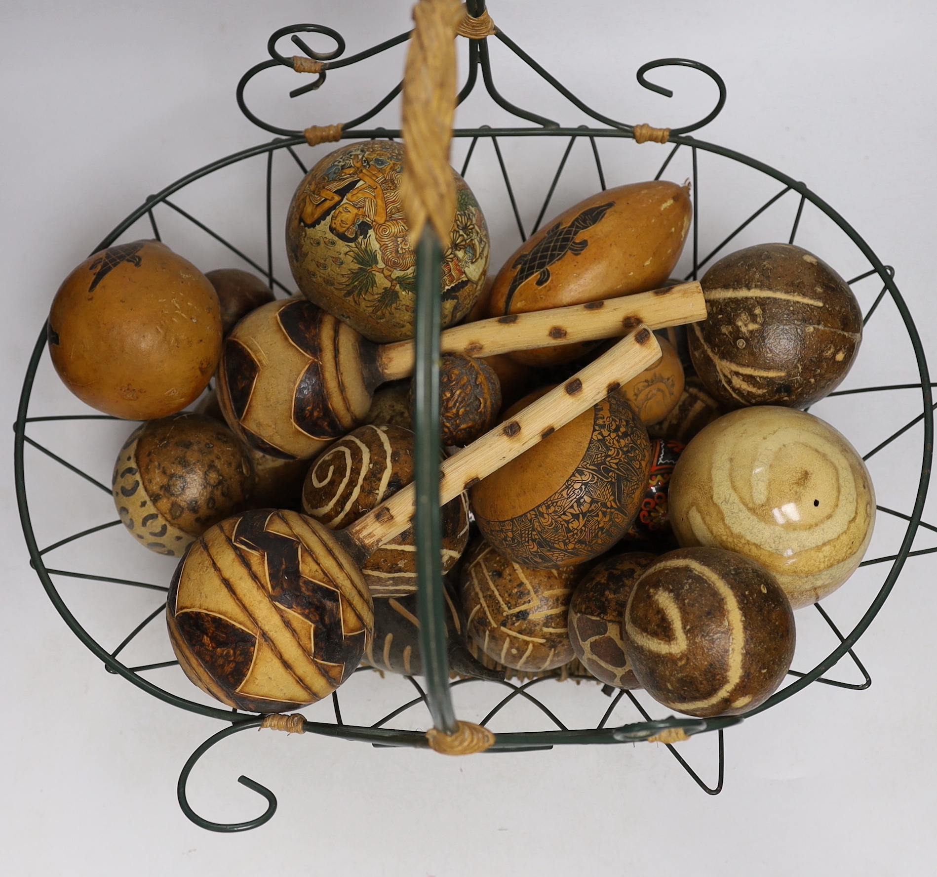 A wirework basket, containing assorted decorated gourds, nuts from Indonesia etc. - Image 3 of 3