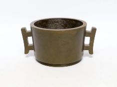 A Chinese bronze censer, of tapering cylindrical form, applied with a pair of trellis shaped
