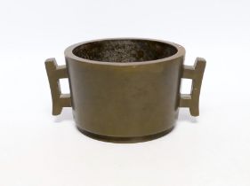 A Chinese bronze censer, of tapering cylindrical form, applied with a pair of trellis shaped