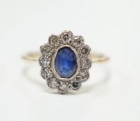 An early to mid 20th century 18ct and plat. sapphire and diamond set oval cluster ring, size L,