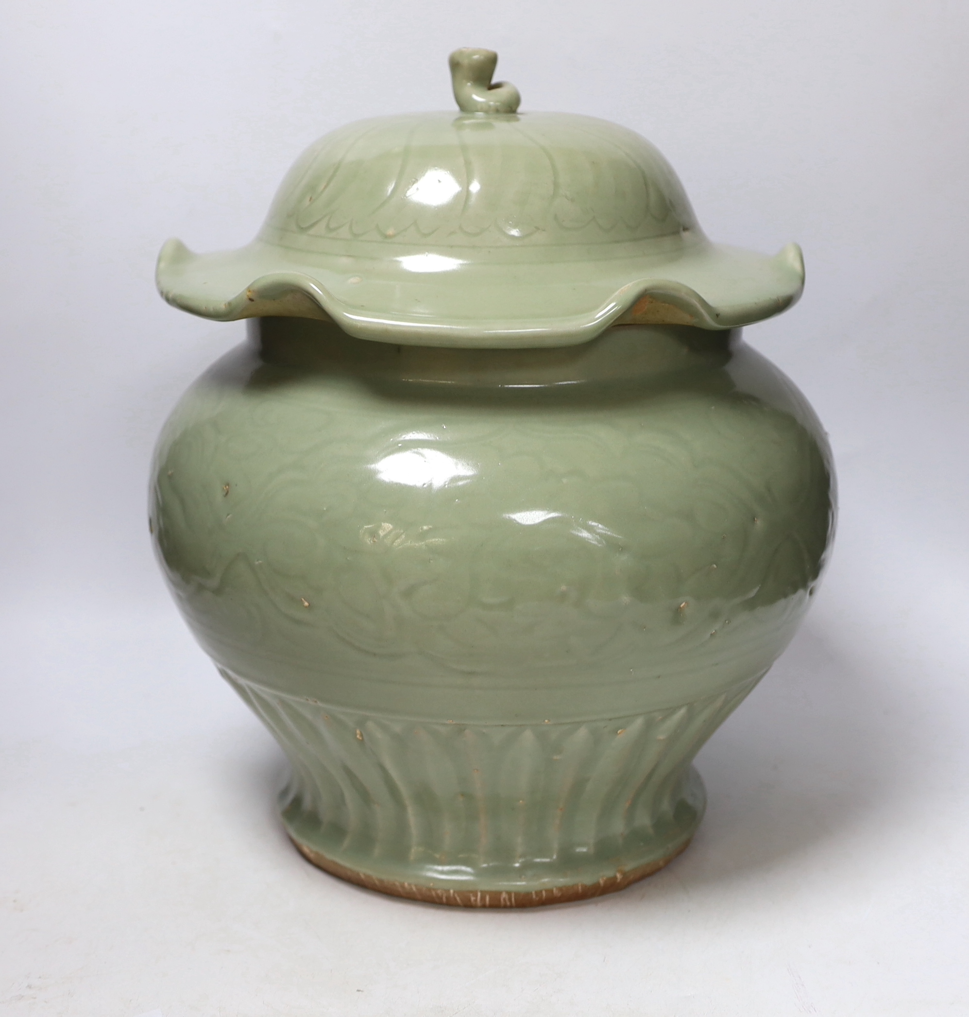A large Chinese celadon jar and cover, Ming dynasty or later, the lotus leaf shaped cover above a - Image 2 of 5