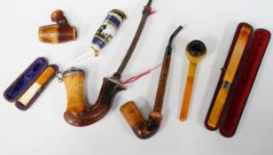 Seven pipes, three with amber mouthpieces, two cased and two without mouthpieces, longest cased pipe
