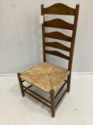 An early 20th century Arts and Crafts ash rush seat ladderback nursing chair possibly by Edward