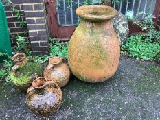 A large circular terracotta planter, height 78cm, together with three similar smaller jars