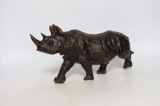 A carved heavy rootwood model of a rhinoceros, 33cm