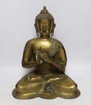 A Chinese or South East Asian bronze figure of seated buddha, 42cm high