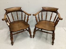 A pair of Victorian elm and beech smoker's bow elbow chairs, width 67cm, depth 50cm, height 82cm