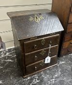 A miniature oak, brass mounted table top desk with three drawers, incorporating old timbers, 36cm