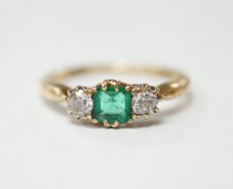 An early to mid 20th century 18ct, emerald and diamond set three stone ring, size O/P, gross