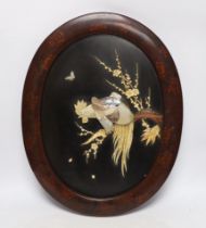 A Japanese bone and mother of pearl inlaid oval panel, cockerel amongst flowers