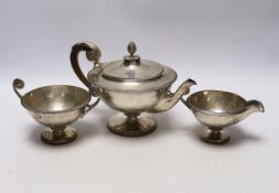 A 1930's silver circular pedestal three piece tea set, Goldsmiths & Silversmiths Co Ltd, London,