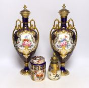 A pair of Royal Crown Derby porcelain urns and covers together with a smaller example and an Imari