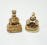 Two 19th century yellow metal overlaid fob seals, the largest 32mm with inset citrine carved with