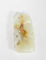 A Chinese pale celadon and russet jade carving of a prunus bough, 5.4cm