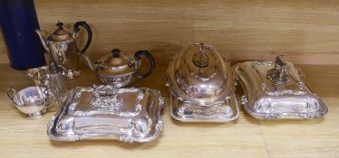 A quantity of silver plate including tea and coffee pots with ebonised handles and a pair of serving