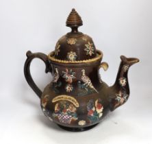 A Measham Barge ware glazed pottery teapot, decorated in relief, 35cm wide