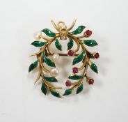 A yellow metal, green enamel, ruby and seed pearl cluster set wreath pendant brooch, 29mm, gross