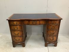 A reproduction George III style serpentine mahogany kneehole desk, width 115cm, depth 53cm height