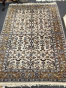 A North West Persian ivory ground rug, 182 x 124cm
