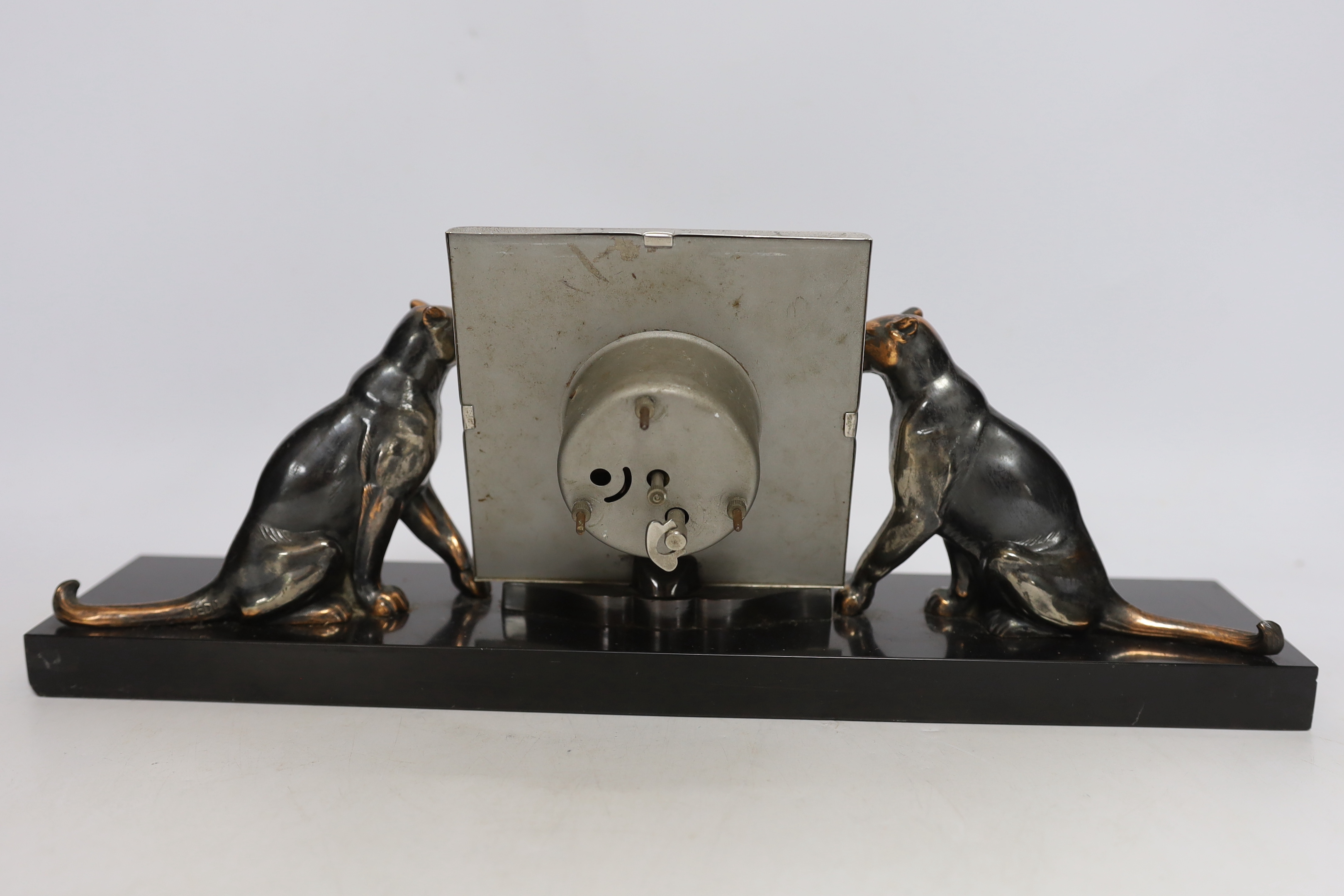 A patinated spelter Art Deco clock surmounted with two panthers, 40cm high - Image 4 of 4