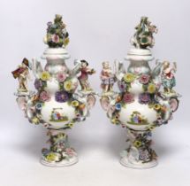 A pair of Sitzendorf floral encrusted and figural vases and covers, late 19th century, 36cm high