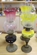 Four Victorian/Edwardian oil lamps with glass shades, tallest 69cm