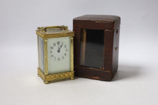 An Edwardian blind fretwork brass carriage timepiece, 12cm, in cloth covered case