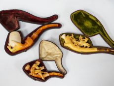 Three cased novelty Meerschaum pipes and pipe bowls, all with amber mouth pieces, one of a horses