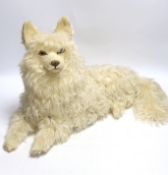 A felt and fur seated dog nightdress case, with articulated head and tail, 50cm long