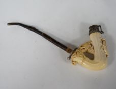 An ornate Meerschaum pipe, with carved monogram on the bowl and metal cover, 30cm long