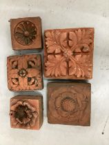 Five square terracotta tiles, largest 24cm