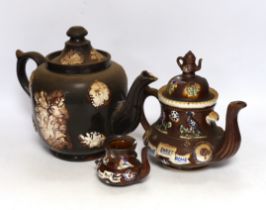 Three 19th century various sized Measham Barge ware teapots, largest 22cm high