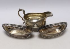 A George V silver sauceboat, Thomas Bradbury & Sons, Sheffield, 1919 and a pair of earlier pierced