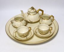 A late 19th century Royal Worcester ivory ground and gilt decorated cabaret set, tray 37cm in