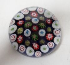 A Clichy translucent blue ground millefiori glass paperweight, 7cm in diameter