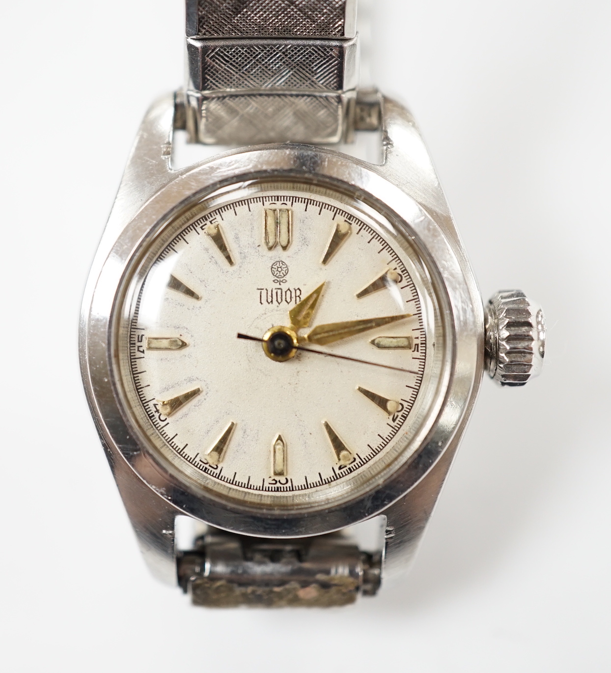 A lady's stainless steel Tudor manual wind wrist watch, with baton numerals, on an associated