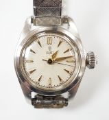 A lady's stainless steel Tudor manual wind wrist watch, with baton numerals, on an associated