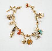 An Italian 750 charm bracelet, hung with eleven assorted charms including 9ct, yellow metal and