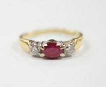 A modern 18ct gold, ruby and diamond set three stone ring, shank misshapen, gross weight 2.9 grams.
