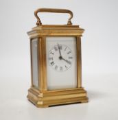 A small brass cased carriage timepiece with key, 9cm high