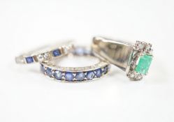 An 18k white metal, emerald and diamond set dress ring, size O, a white metal and sapphire set