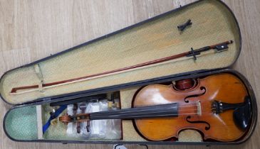 A mid 19th century cased French violin, length of body 35.5cm, with bow, simulated ivory tip