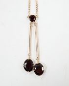 A 9k and three stone garnet set double drop pendant necklace, overall 52cm, gross weight 5.3 grams.