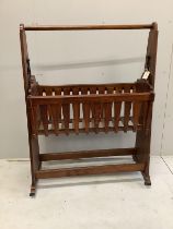 An Arts and Crafts oak rocking crib, width 97cm, height 130cm