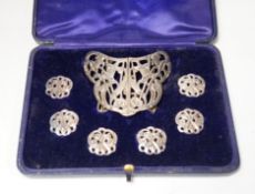 An Edwardian cased silver buckle and button set comprising a buckle and six buttons, Samuel Jacob,