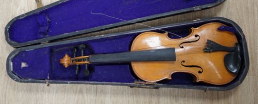 A wooden cased early 20th century Czechoslovakian student’s violin, bears ‘Copy of Stradivarius’