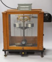 A teak cased scientific balance, Stanton Instruments Ltd. scales Model AD2, with sliding front