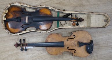 Two early 20th century violins, one in the remains of a case, both for restoration, length of